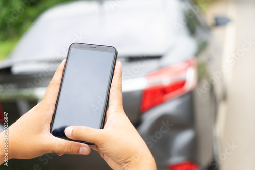 Man Hand Taking Photo Of Car Accident Through Smartphone, close up..Insurance agent using smart phone to take a photo photographing vehicle of damage car crash.