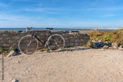 French landscape - Bretagne. Old bicycle with a beautiful rocky beach and view over the sea.