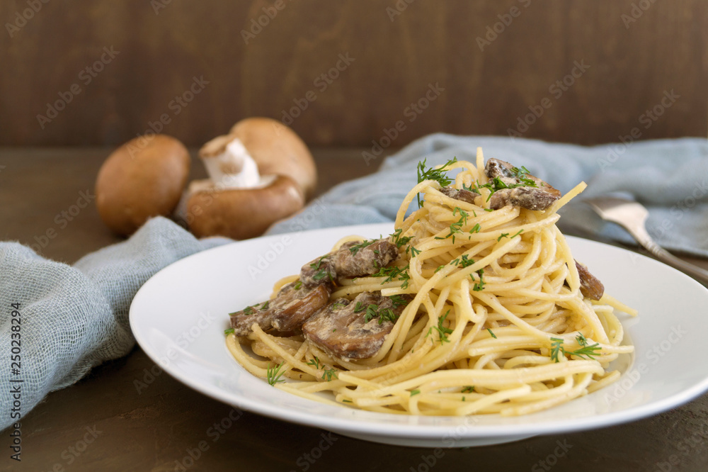 Spaghetti with mushrooms in cream sauce. on dark background