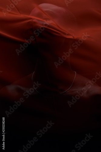 Art portrait of black man posing behind red fabric. Sensual. Art performance, acting.