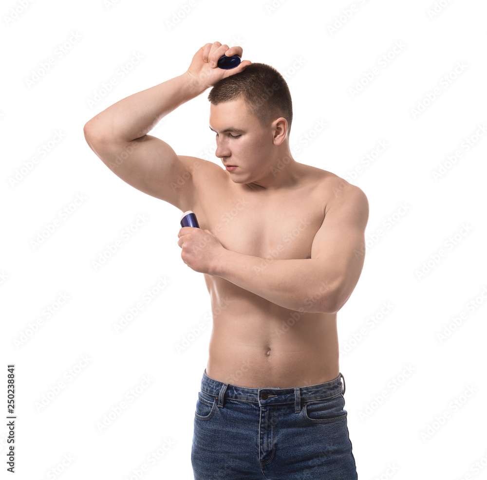 Fototapeta premium Handsome young man with deodorant on white background