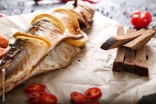 Tasty mackerel fish on parchment, closeup