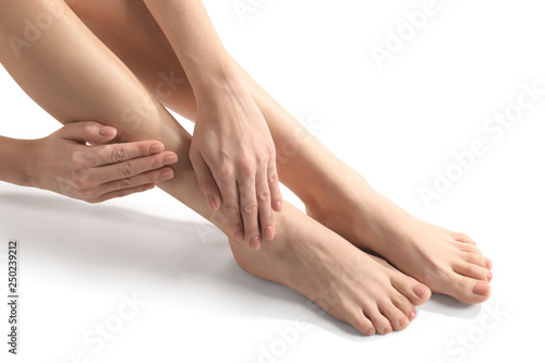 Legs of young woman with beautiful pedicure on white background