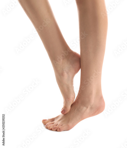 Legs of young woman with beautiful pedicure on white background © Pixel-Shot