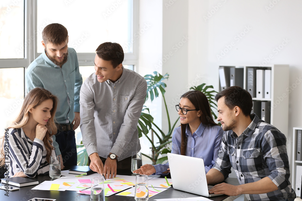 Group of people discussing business plan in office Group of people discussing business plan in office