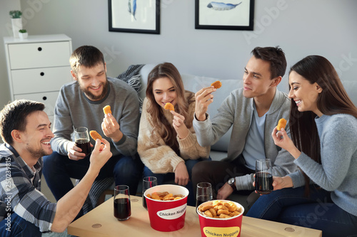 Group of friends eating nug...