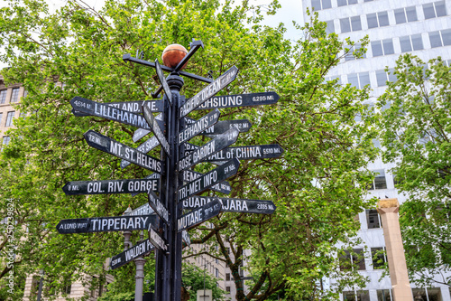 Famous signpost of directions to world landmarks at Pioneer Courthouse Square, Portland, Oregon photo