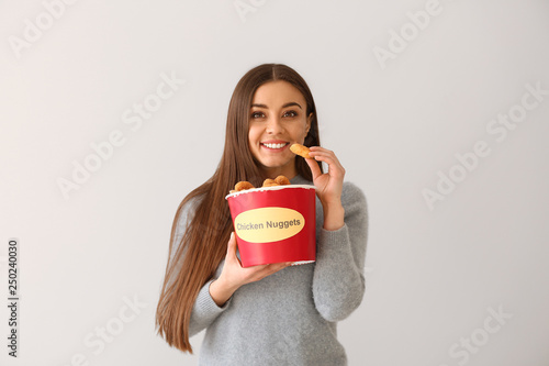 Young woman with bucket of ...