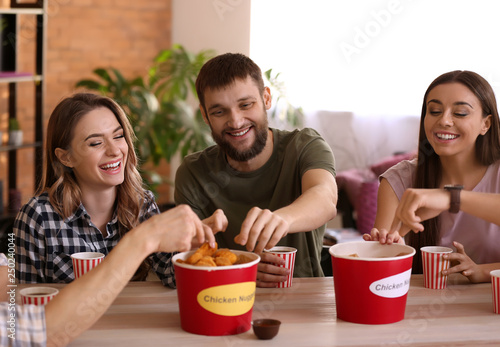 Group of friends eating nug...