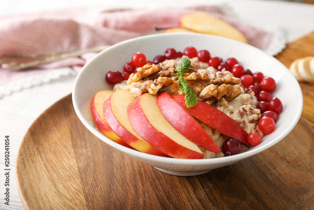 Bowl with tasty oatmeal on table Bowl with tasty oatmeal on table