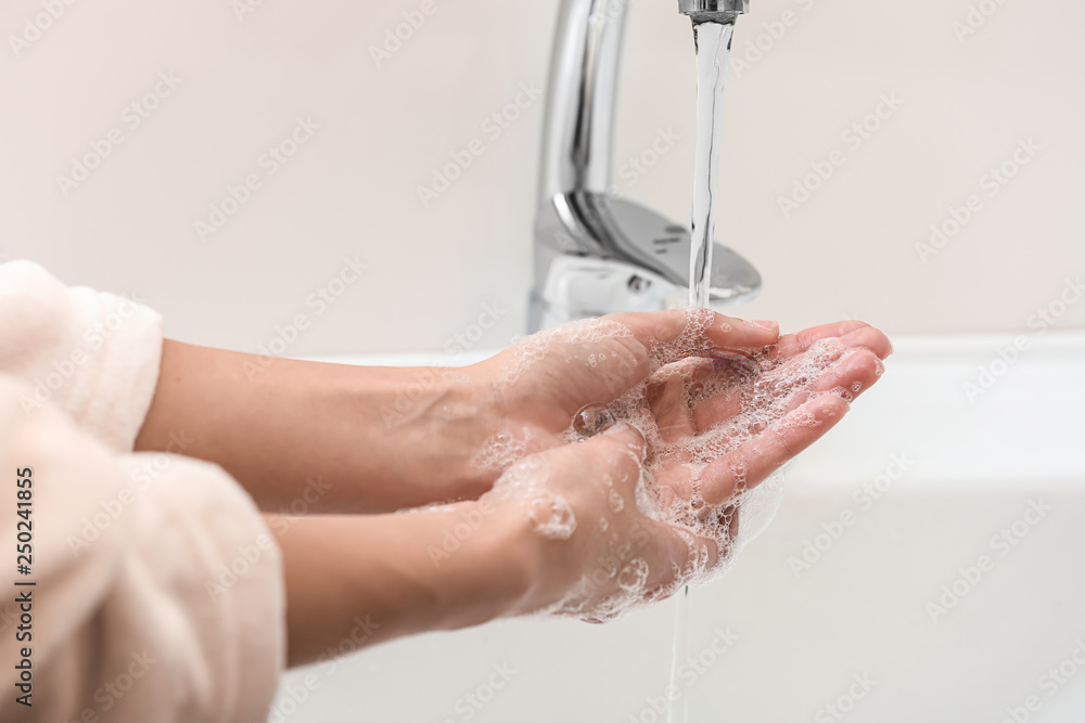 Woman washing hands in sink Woman washing hands in sink