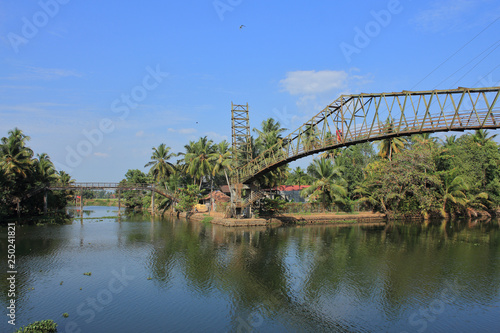 An old iron bridge across the beautiful backwaters in Kerala, India. photo