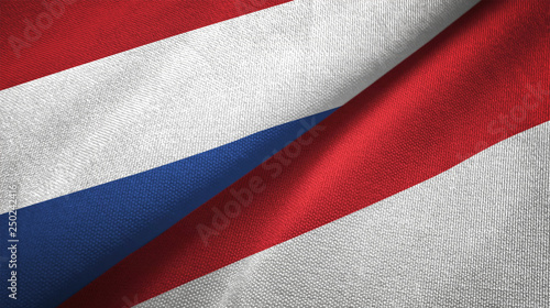 Netherlands and Indonesia two flags textile cloth, fabric texture