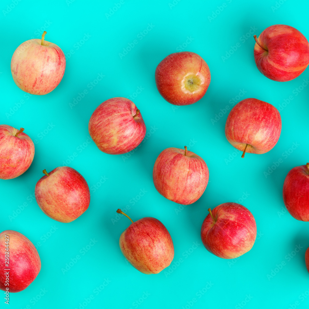 Fruit pattern of red apple on blue background. Flat lay, top view. Pop art design, creative summer concept. Food background. . Creative layout. Fruit pattern of red apple on blue background. Flat lay, top view. Pop art design, creative summer concept. Food background. . Creative layout.