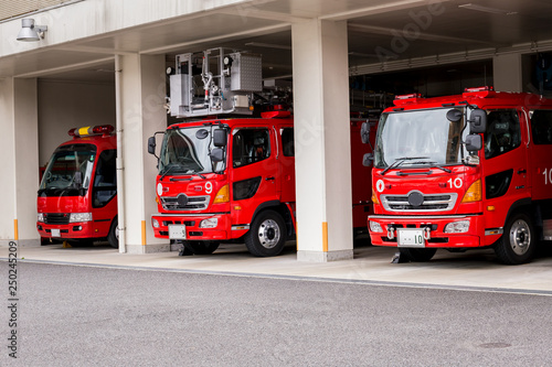 Three fire trucks are in the garage