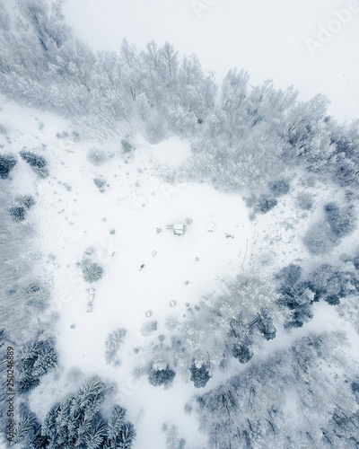 Drone photography of litle Lithuanian countryside Skaistgirys, winter time, moody white drone photo.