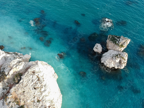 Aerial view of Petra tou Romiou, aka Aphrodite's rock a famous tourist travel destination landmark in Paphos, Cyprus. The sea bay of goddess Afroditi birthplace from above.