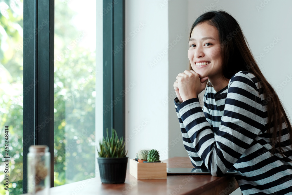 Young asian woman with digital tablet sitting in cafe background, people and technology lifestyle Young asian woman with digital tablet sitting in cafe background, people and technology lifestyle