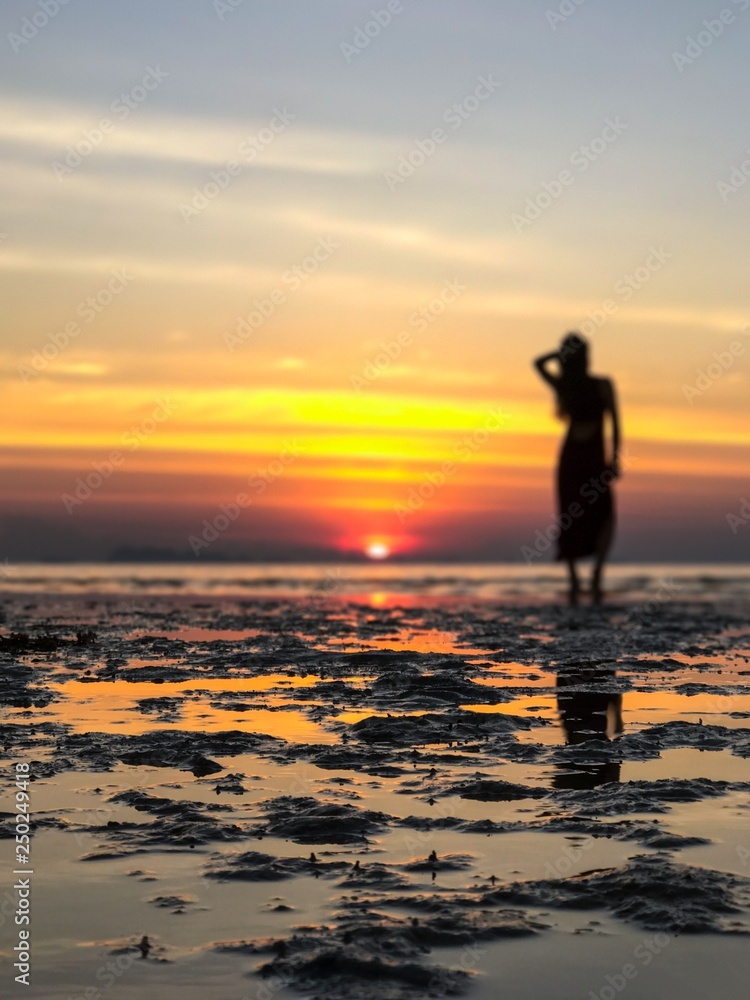 Silhouette Woman On Beach Against Sky During Sunset