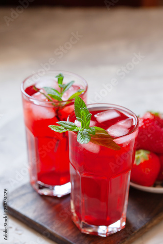 Fresh strawberry lemonade garnished with mint, copy space