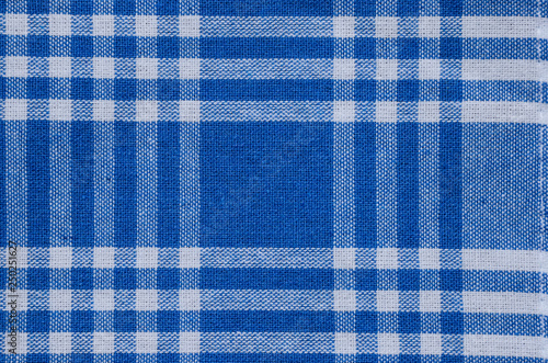 Blue tablecloth, gingham pattern, texture. Textile, checked abstract retro picnic fabric background. 