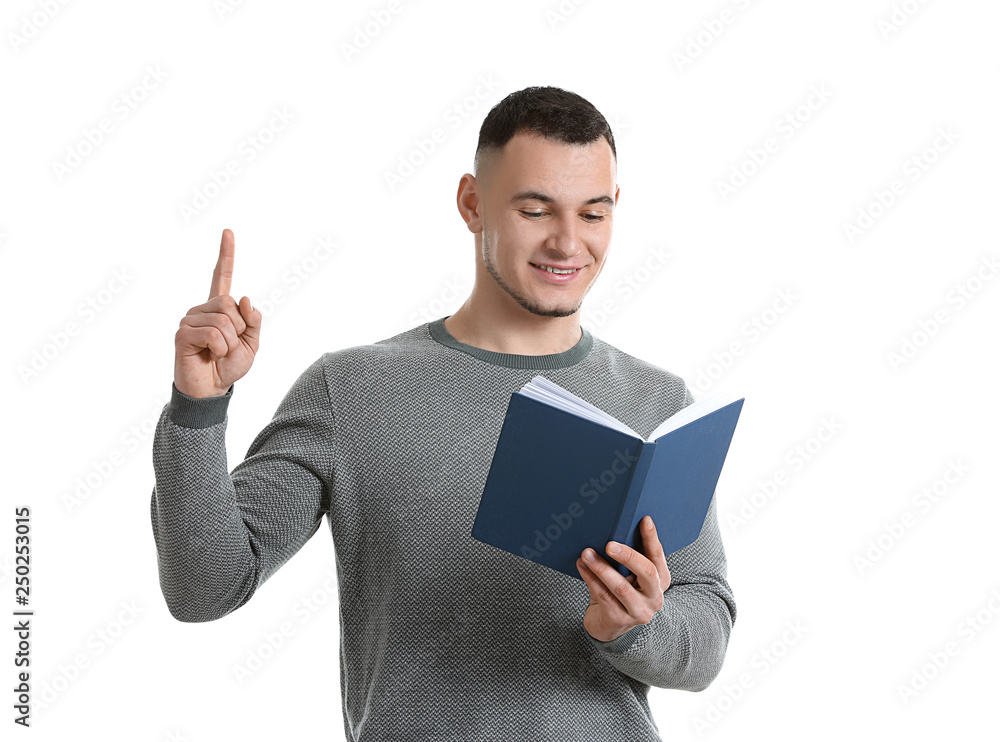 Handsome young man with book and raised index finger on white background Handsome young man with book and raised index finger on white background