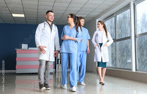 Team of doctors walking down the corridor in clinic