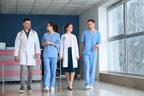Team of doctors walking dow...