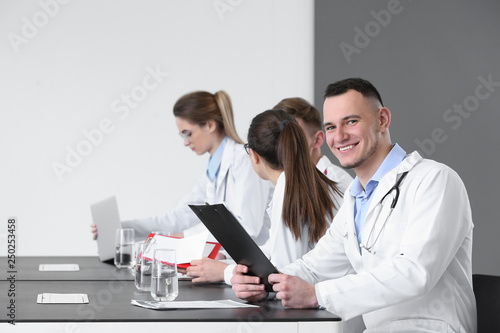 Young doctors sitting at ta...