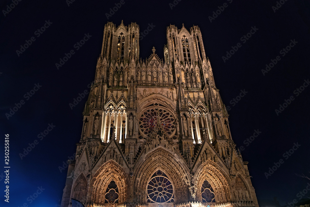 Reims Cathedral at night. This Roman Catholic cathedral was built on the site of the basilica where Clovis was baptized. This major tourist destination receives about 1 million visitors annually.