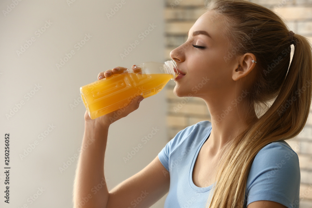 Young woman drinking healthy juice at home Young woman drinking healthy juice at home