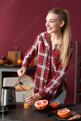 Smiling young woman pouring...