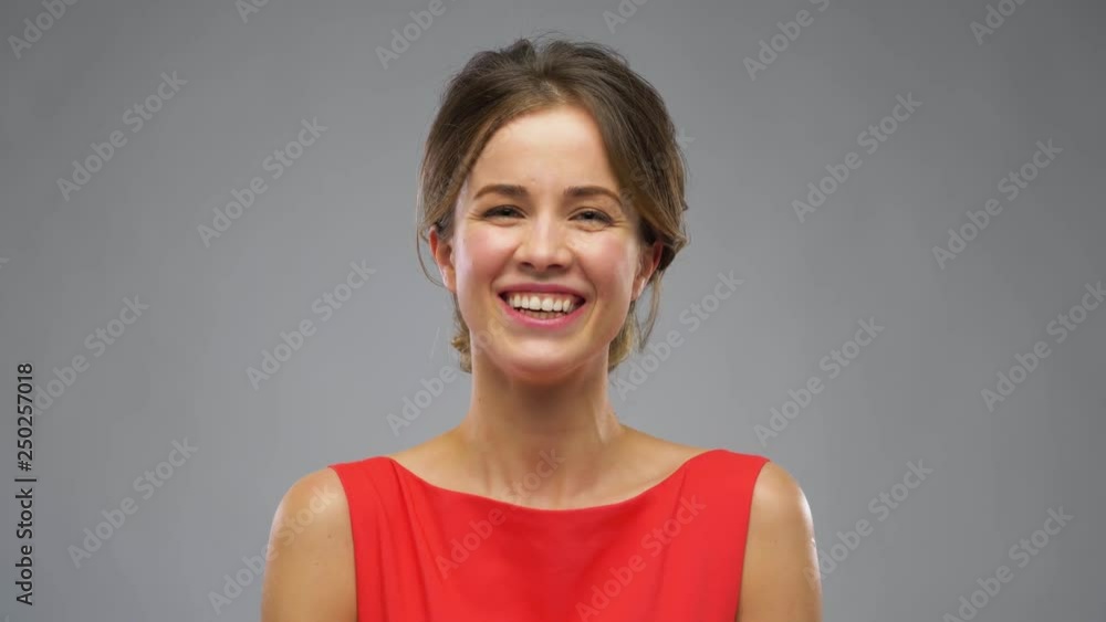 video blogging, interview and people concept - beautiful young woman in red or blogger talking over dark grey background video blogging, interview and people concept - beautiful young woman in red or blogger talking over dark grey background