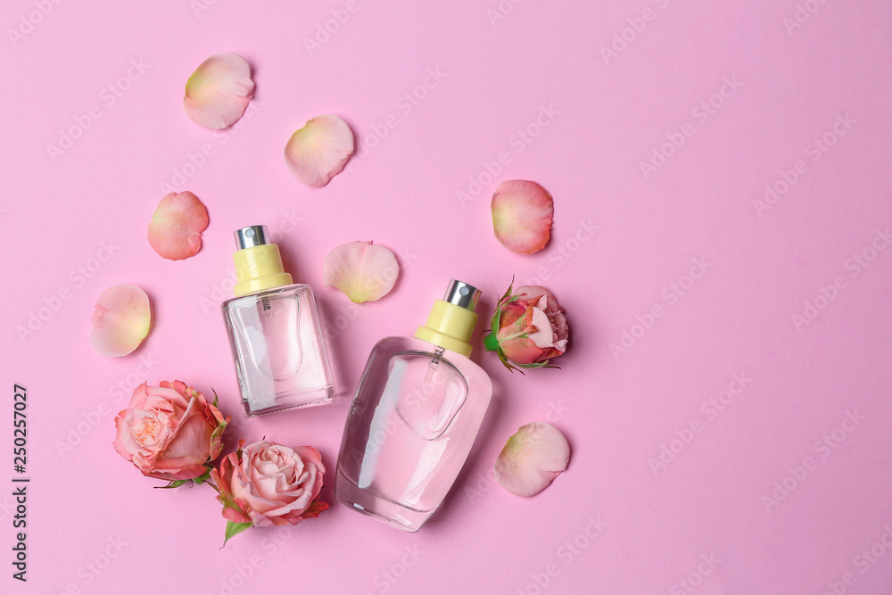 Bottles of perfume and flowers on color background Bottles of perfume and flowers on color background