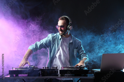 Male DJ playing music in club photo