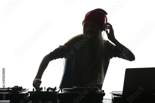 Silhouette of female DJ pla...