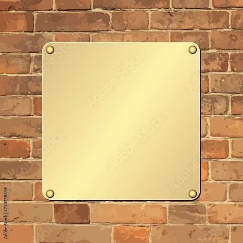 golden plaque on old brick wall