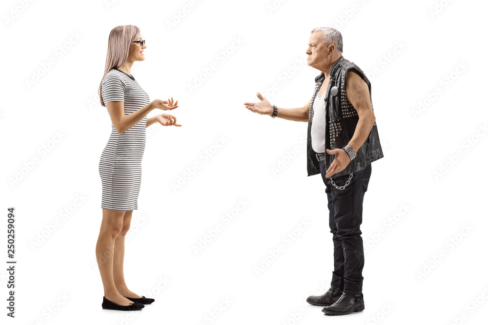 Young woman talking to an angry male punker in a leather vest Young woman talking to an angry male punker in a leather vest