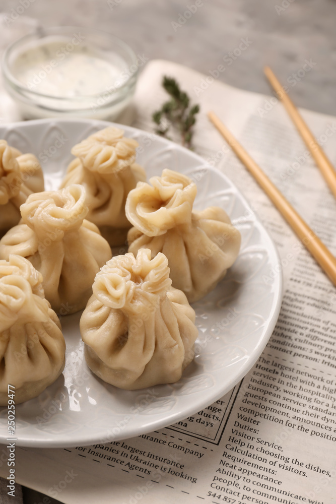 Plate with tasty dumplings on table Plate with tasty dumplings on table