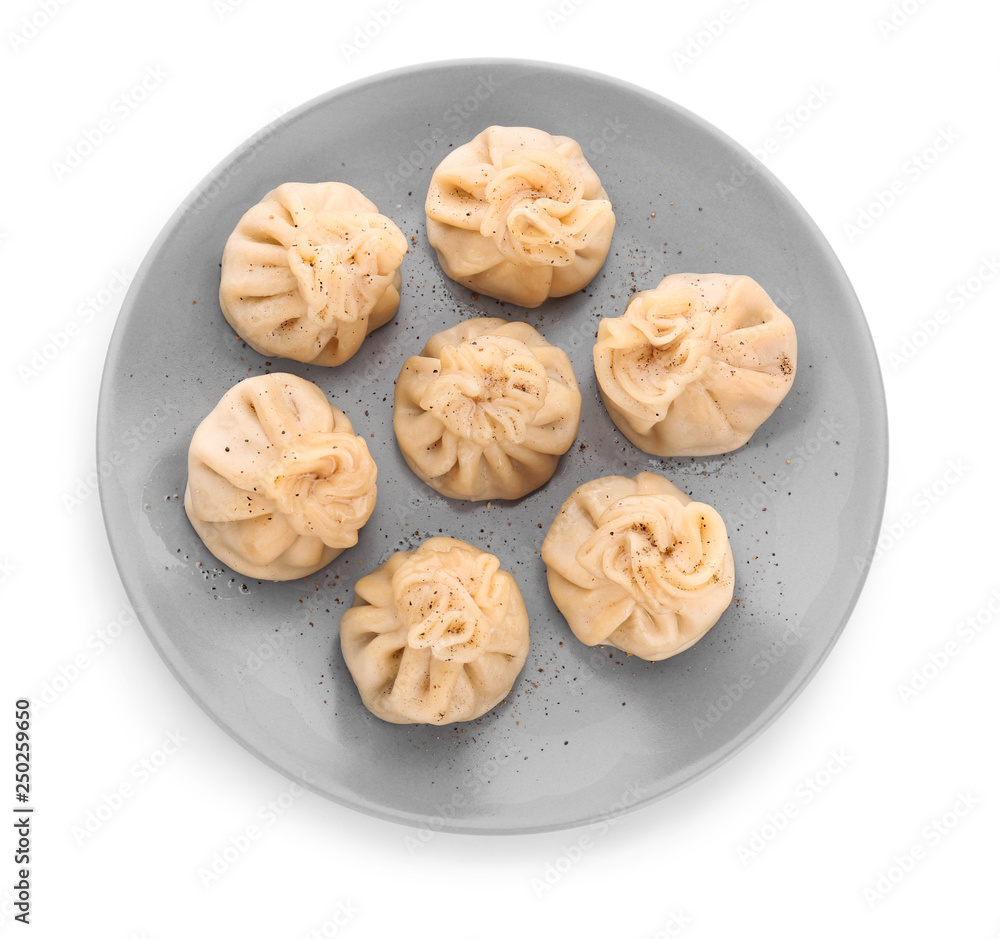 Plate with tasty dumplings on white background