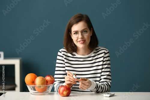 Diabetic woman taking blood...