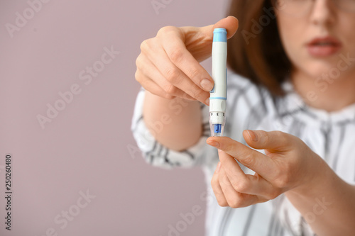 Diabetic woman taking blood...