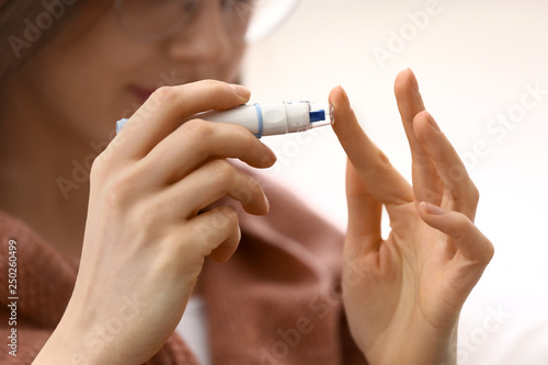 Diabetic woman taking blood...