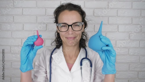 Funny doctor with enemas. Cute woman with medical pears.