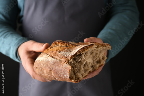 Man with loaf of fresh bread, closeup