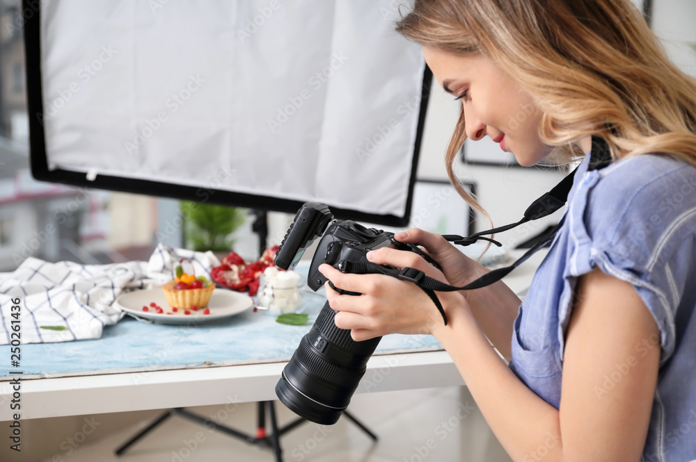 Female food photographer working in home studio