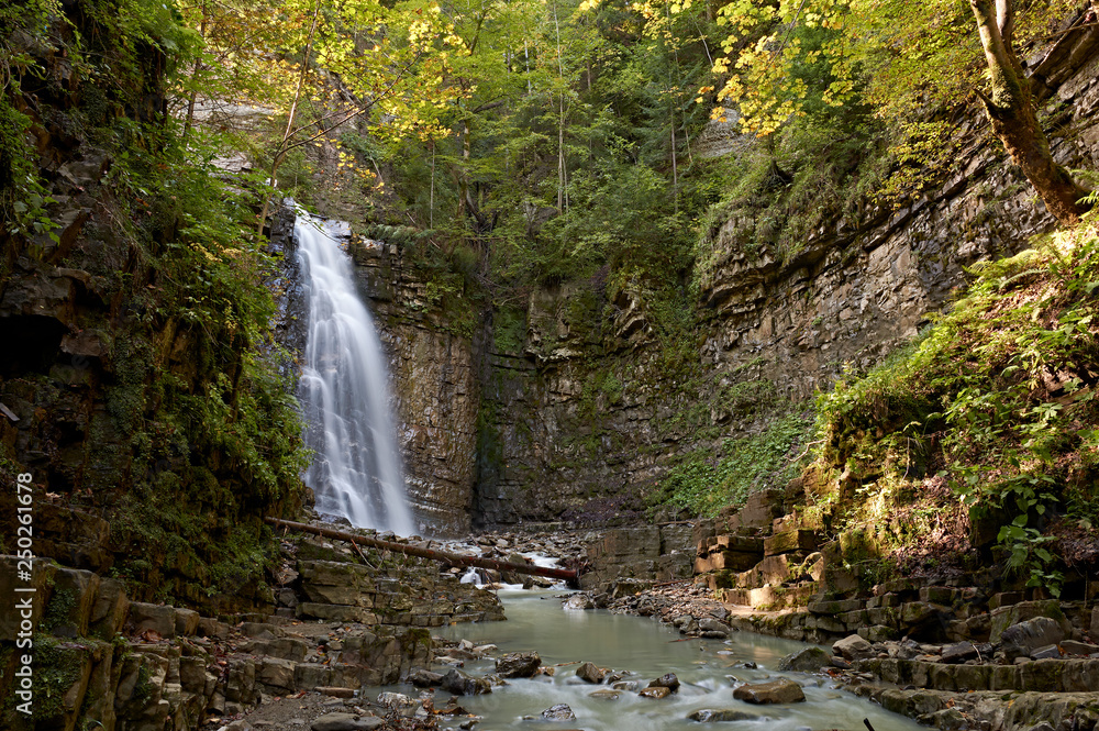 Maniavskyi waterfall in Maniava, Cascade in forest in mountains. Carpathian Mountains, Ivano-Frankivska oblast, Ukraine. Maniavskyi waterfall in Maniava, Cascade in forest in mountains. Carpathian Mountains, Ivano-Frankivska oblast, Ukraine.