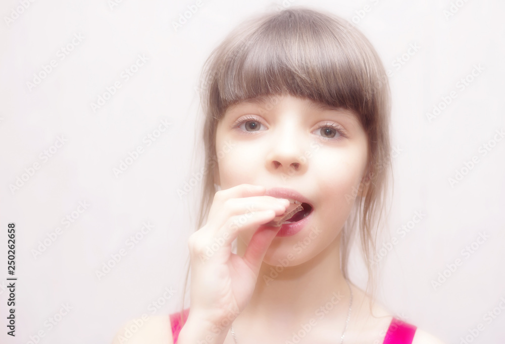 Cute and beautiful girl with pleasure going to eat chocolate. Cute and beautiful girl with pleasure going to eat chocolate.
