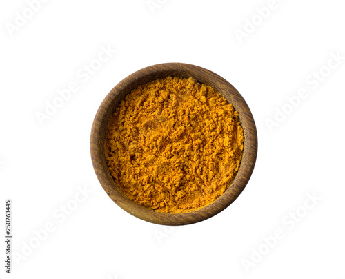 Turmeric in a wooden bowl isolated on white. Spice turmeric isolated on white background. Turmeric with copy space for text.