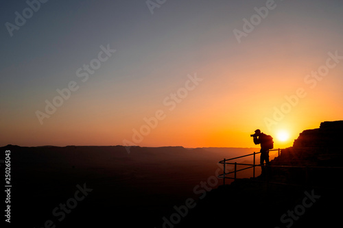 Photographer who shoots a sunset in the mountains